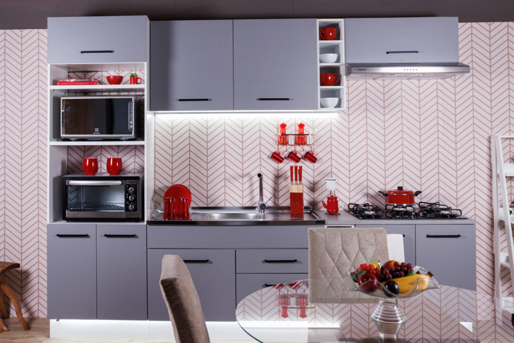 Cozinha Agata Madesa, nas cores branco e cinza, decorada com utensílios vermelhos para trazer cores vibrantes.