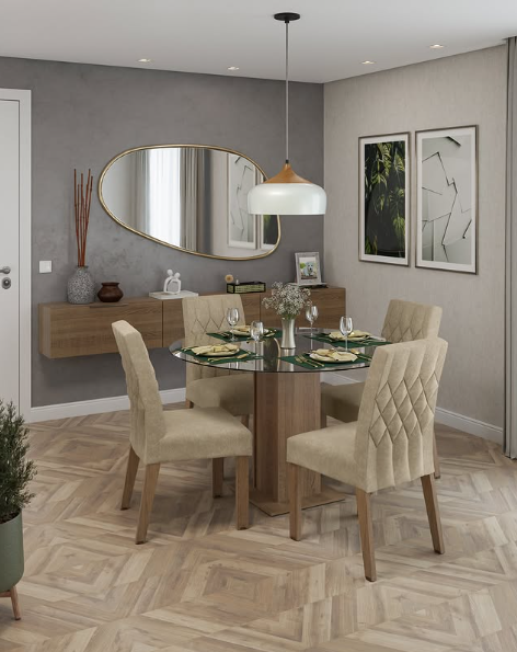 Sala de jantar com mesa redonda de vidro, quatro cadeiras bege, armários aéreos usados como aparador, parede cinza com espelho oval dourado, obras de arte modernas, luminária pendurada e piso de parquet claro.