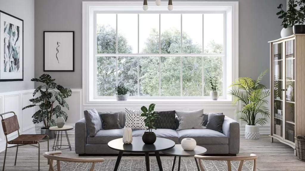 Outro exemplo de sala de estar decorada com o estilo escandinavo, dessa vez usando a cor cinza na decoração, como no sofá.